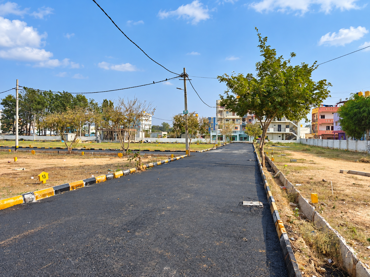 Asphalt road with painted kerbs in a plotted layout