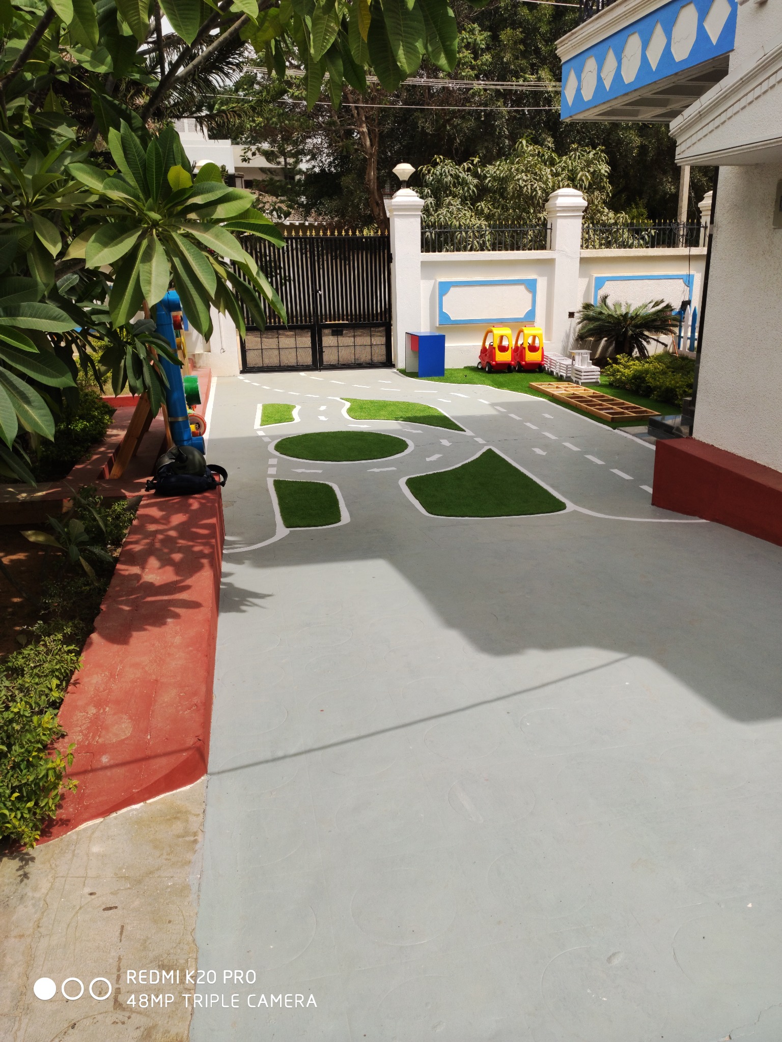Footprints Preschool outdoor play area with a winding path and lawn