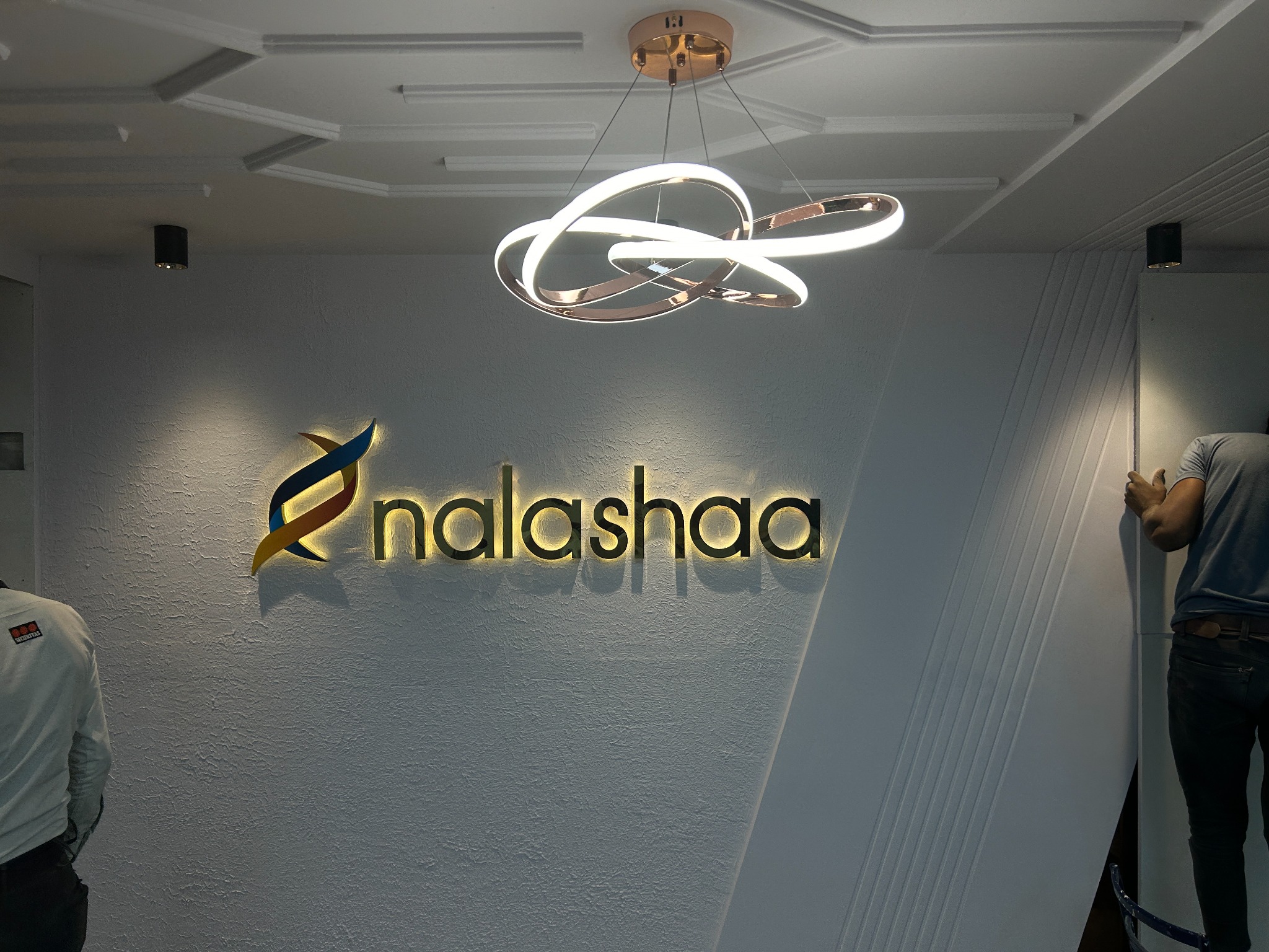 Nalashaa Solutions reception with illuminated branding and decorative ceiling